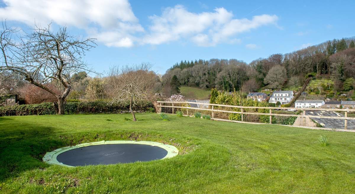 There is a trampoline in the garden, set into the lawn.