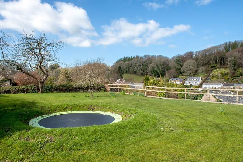 There is a trampoline in the garden, set into the lawn.
