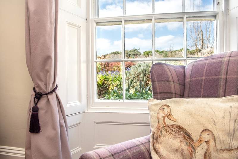 The sitting-room enjoys views over the garden.