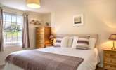 Bedroom 2 is decorated in soft hues. - Thumbnail Image