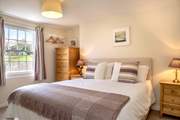 Bedroom 2 is decorated in soft hues.