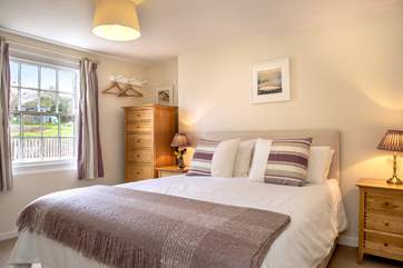 Bedroom 2 is decorated in soft hues.
