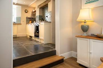 Steps lead up from the dining-area to the kitchen.