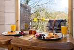 Tuck into a scrumptuous breakfast, taking in the view.