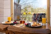 Tuck into a scrumptuous breakfast, taking in the view.