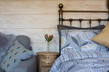 The cabin is decorated with a calming colour scheme of soft greys and whites, with a hint of mustard yellow.