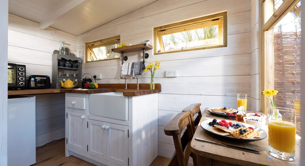 At the far end of the treehouse is the well-equipped kitchen, complete with an electric mini oven, fridge, kettle and toaster.