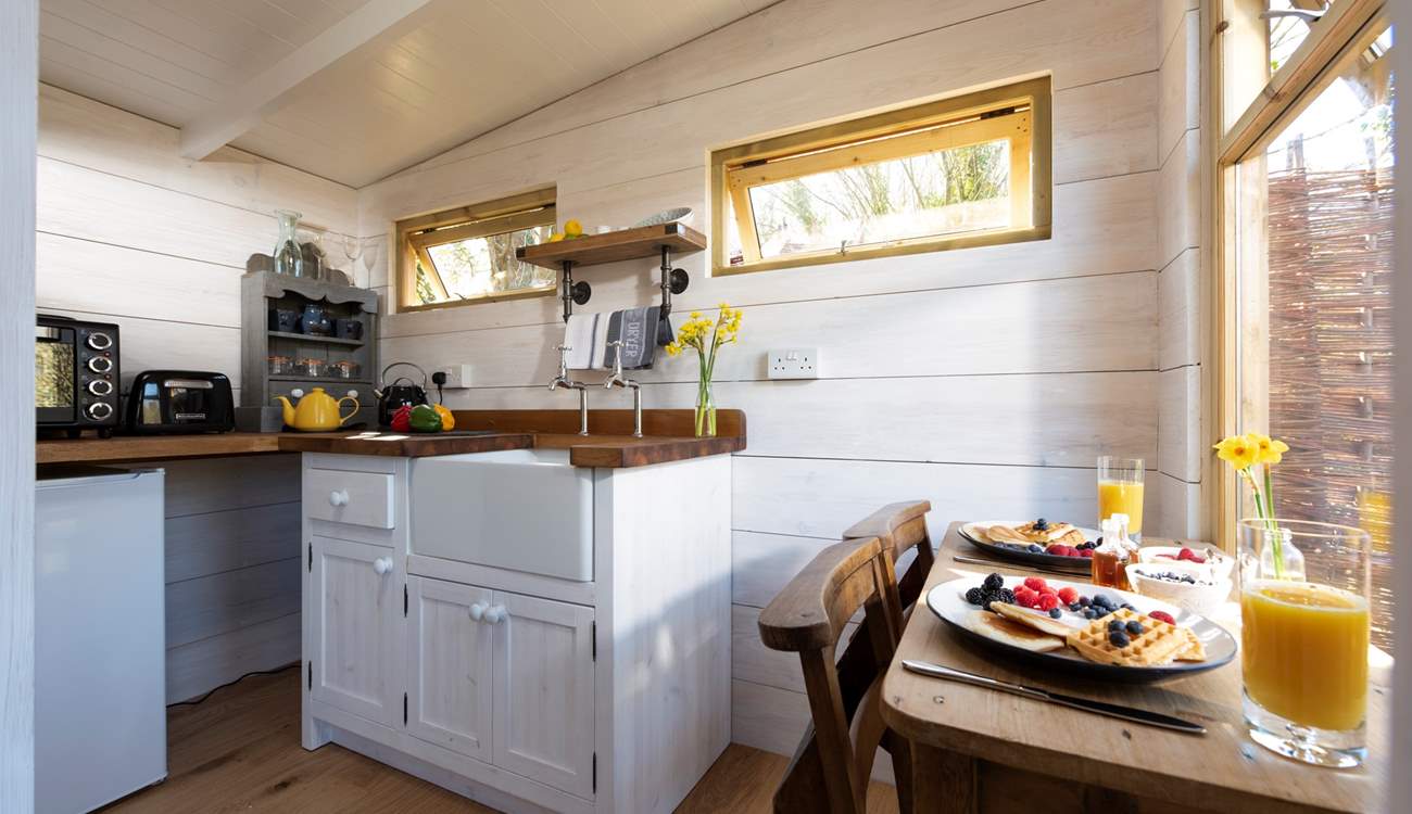 At the far end of the treehouse is the well-equipped kitchen, complete with an electric mini oven, fridge, kettle and toaster.
