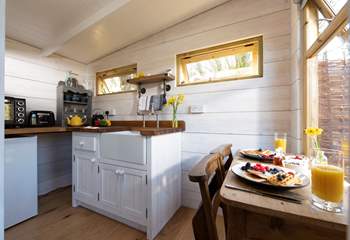 At the far end of the treehouse is the well-equipped kitchen, complete with an electric mini oven, fridge, kettle and toaster.