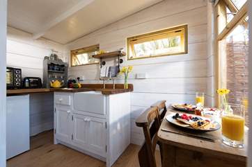 At the far end of the cabin is the compact but well-equipped kitchen, complete with an electric mini oven, fridge, kettle and toaster.