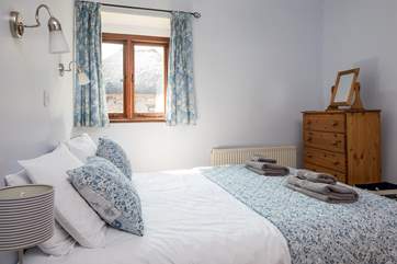 Light and airy, Bedroom 1 is very cute and welcoming.