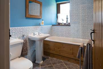The ground floor bathroom is situated next to Bedroom 1 (up the steps).