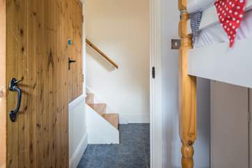 The steps leading down from the living-area into the utility-room which then leads into the bunk room.