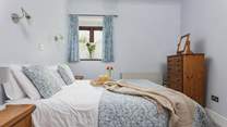 Light and airy, Bedroom 1 is very cute and welcoming.