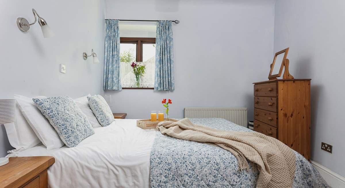 Light and airy, Bedroom 1 is very cute and welcoming.