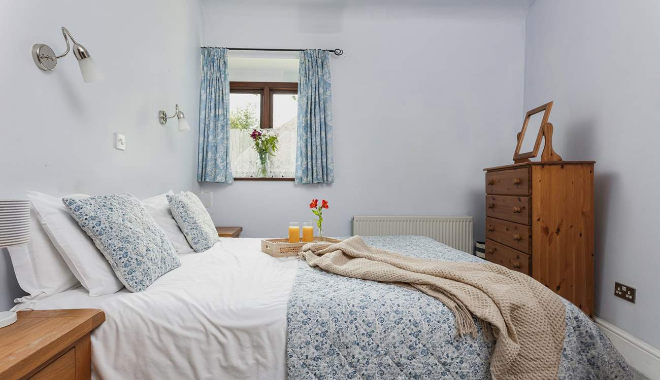 Light and airy, Bedroom 1 is very cute and welcoming.