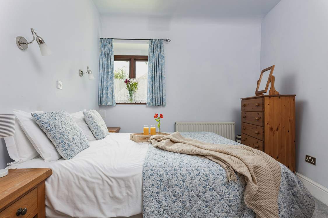 Light and airy, Bedroom 1 is very cute and welcoming.