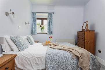 Light and airy, Bedroom 1 is very cute and welcoming.