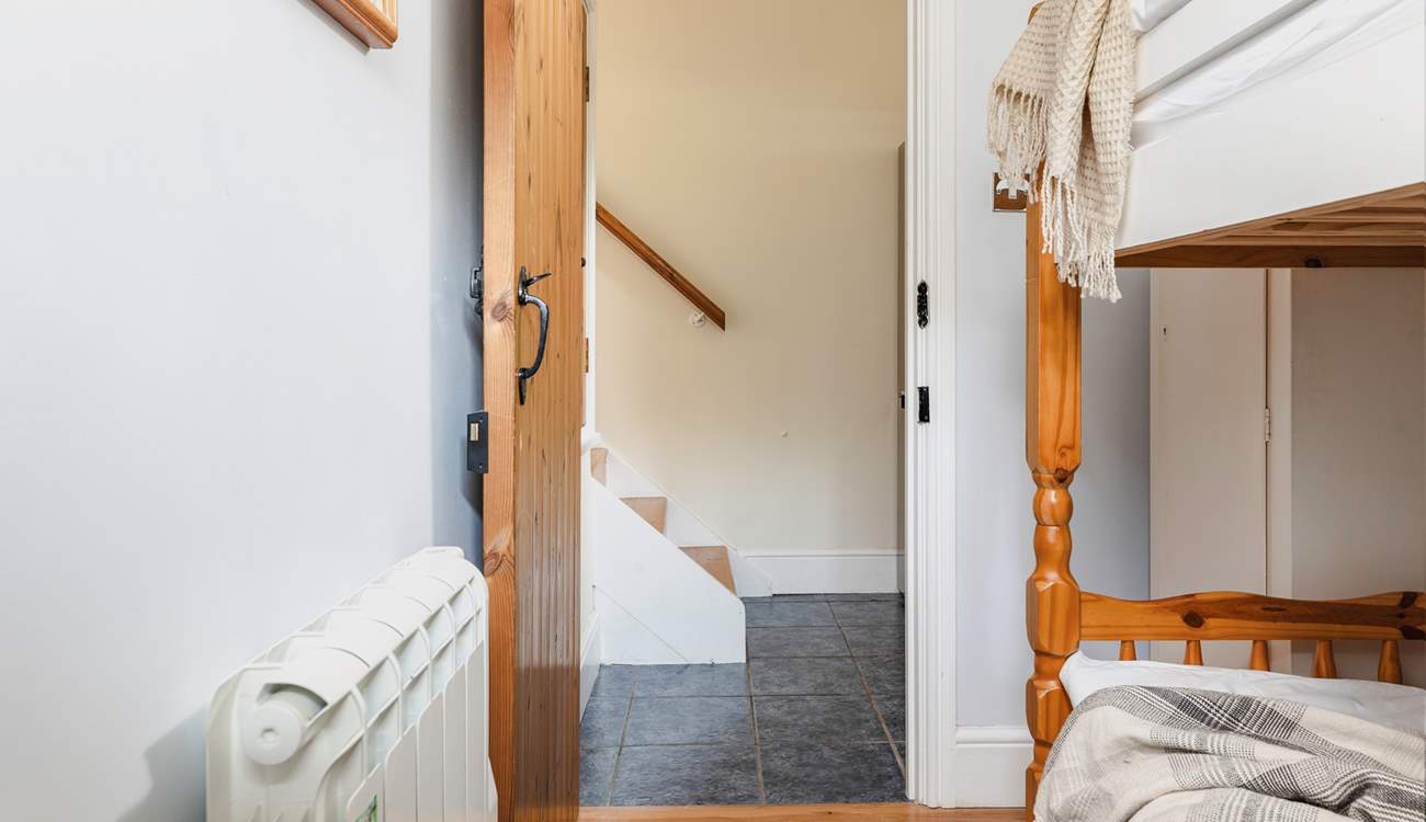 The steps leading down from the living-area into the utility-room which then leads into the bunk room.