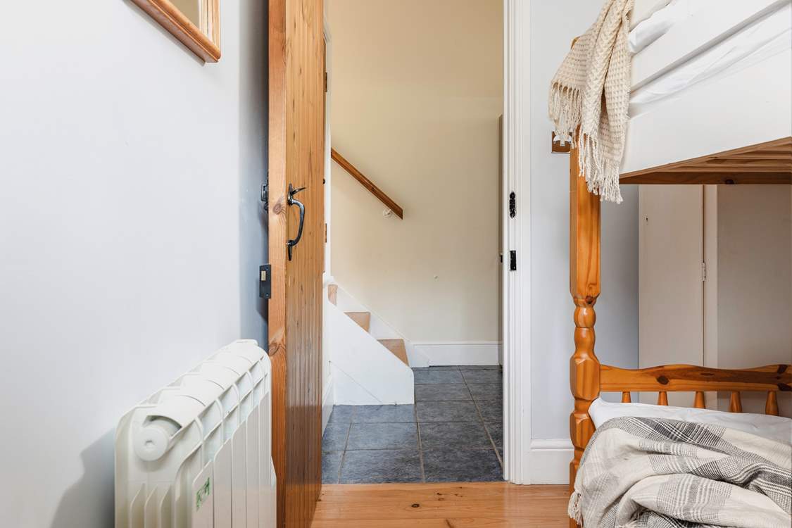 The steps leading down from the living-area into the utility-room which then leads into the bunk room.