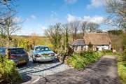 There is parking for two cars to the side of the cottage.