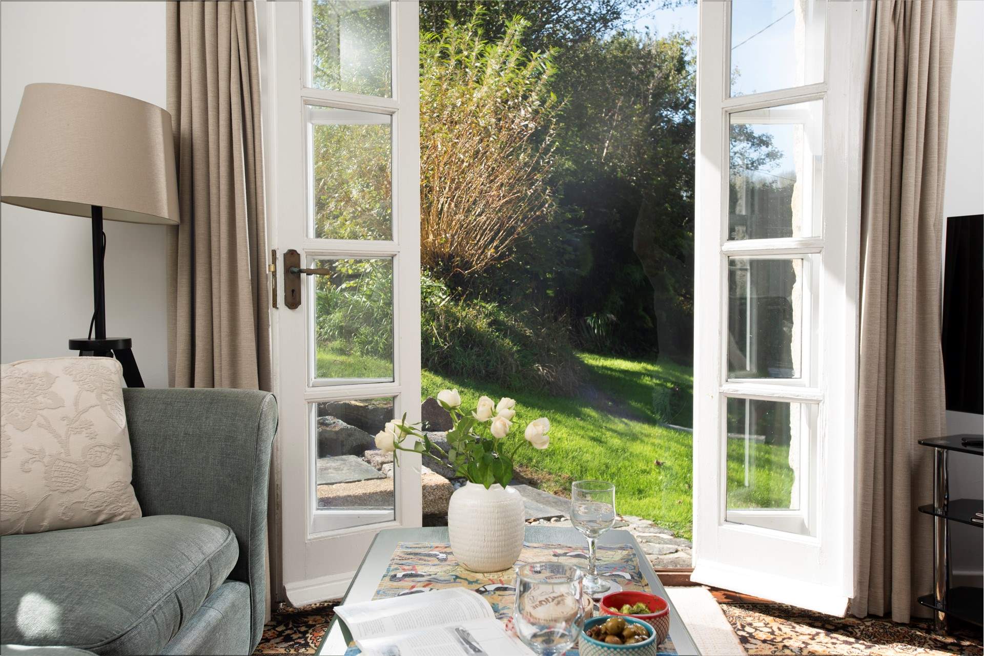 Open up the double doors to the mature cottage garden.