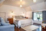 The large bedroom has a super-king bed and overlooks the cottage's pretty front garden. 