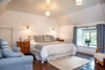 The large bedroom has a super-king bed and overlooks the cottage's pretty front garden.