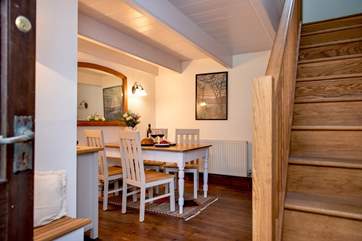 The front door opens to the dining-area and stairs go up to the bedroom and bathroom.