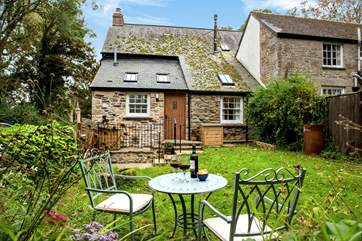 There is a pretty back garden too, surrounded by trees.