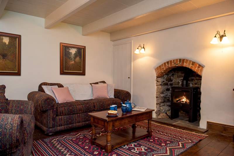 The cosy sitting-room has a warming wood burner (the floorboards are now a light pine and photos to follow). 