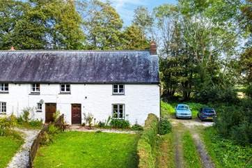 Rosemerryn Cottage is on the right, it has a pretty front garden and you can see the two car parking spaces.