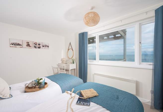 Bedroom 2 styled with delicate coastal hues that co-ordinate with the fabulous view.