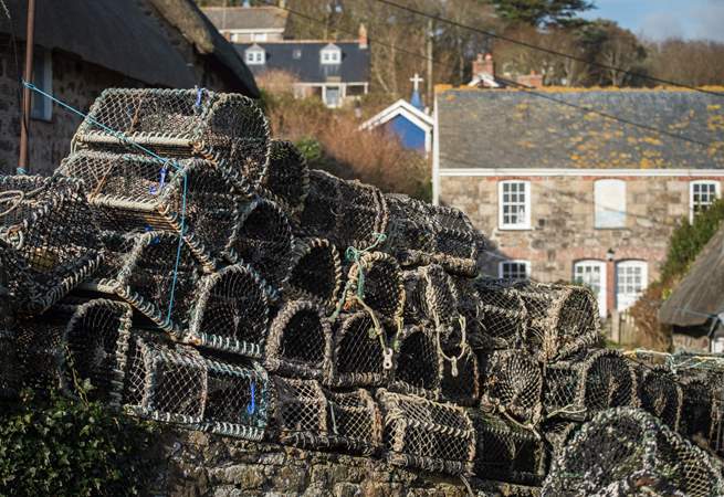 Lobster pots line the wall in Cadgwith.