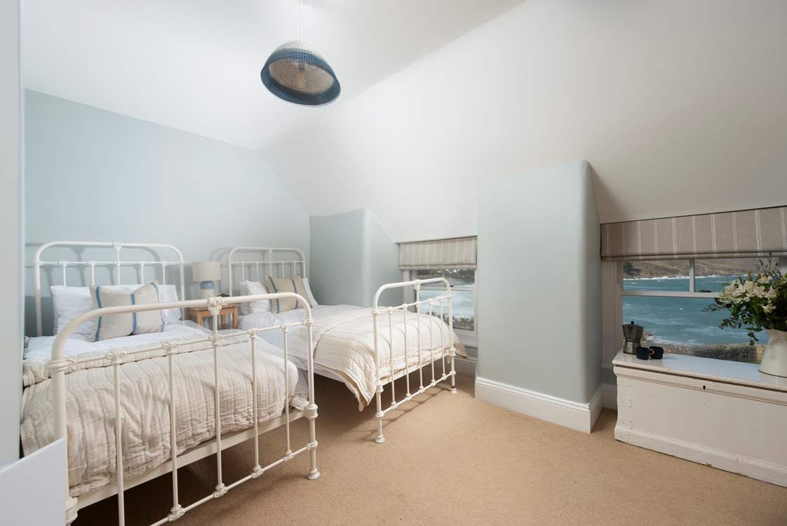 The twin bedroom's calming palette, matching those mesmerising sea views will surely invite a restful night's slumber.