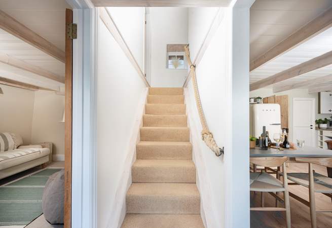 Traditional steep stairs take you to the beautifully appointed bedrooms and bathroom. 