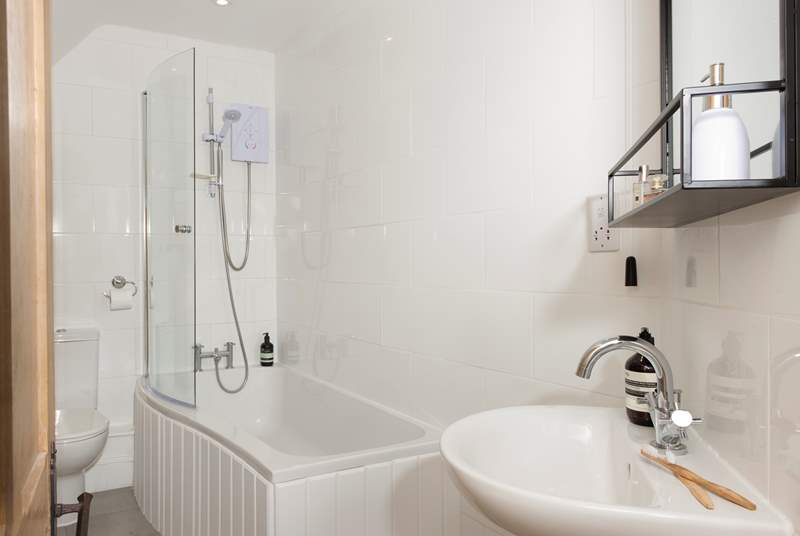 The light, white and bright family bathroom invites invigorating showers or soothing soaks.