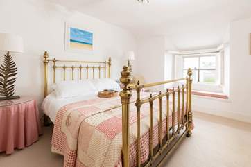 Bedroom 1 has a beautiful bedstead.