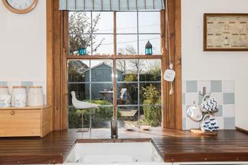The kitchen looks out onto the pretty enclosed outside area.