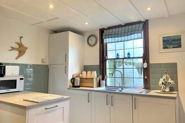 The newly fitted kitchen overlooks the garden.