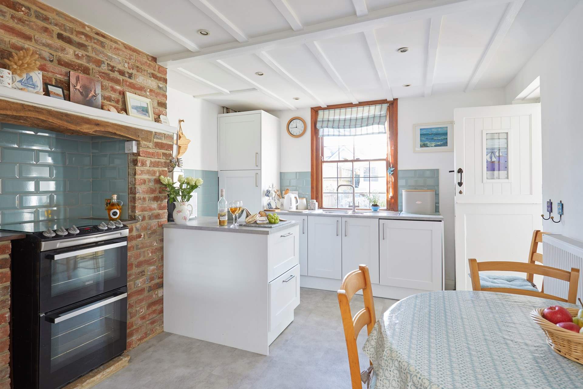 The homely kitchen is fully equipped for family meals.