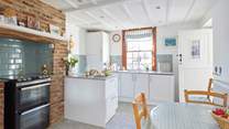 The homely kitchen is fully equipped for family meals.