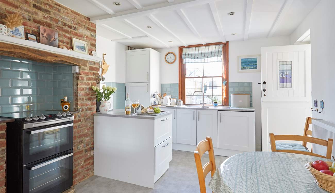 The homely kitchen is fully equipped for family meals.