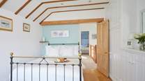 Bedroom 1 with double bed and en suite shower-room overlooks the pretty patio area.