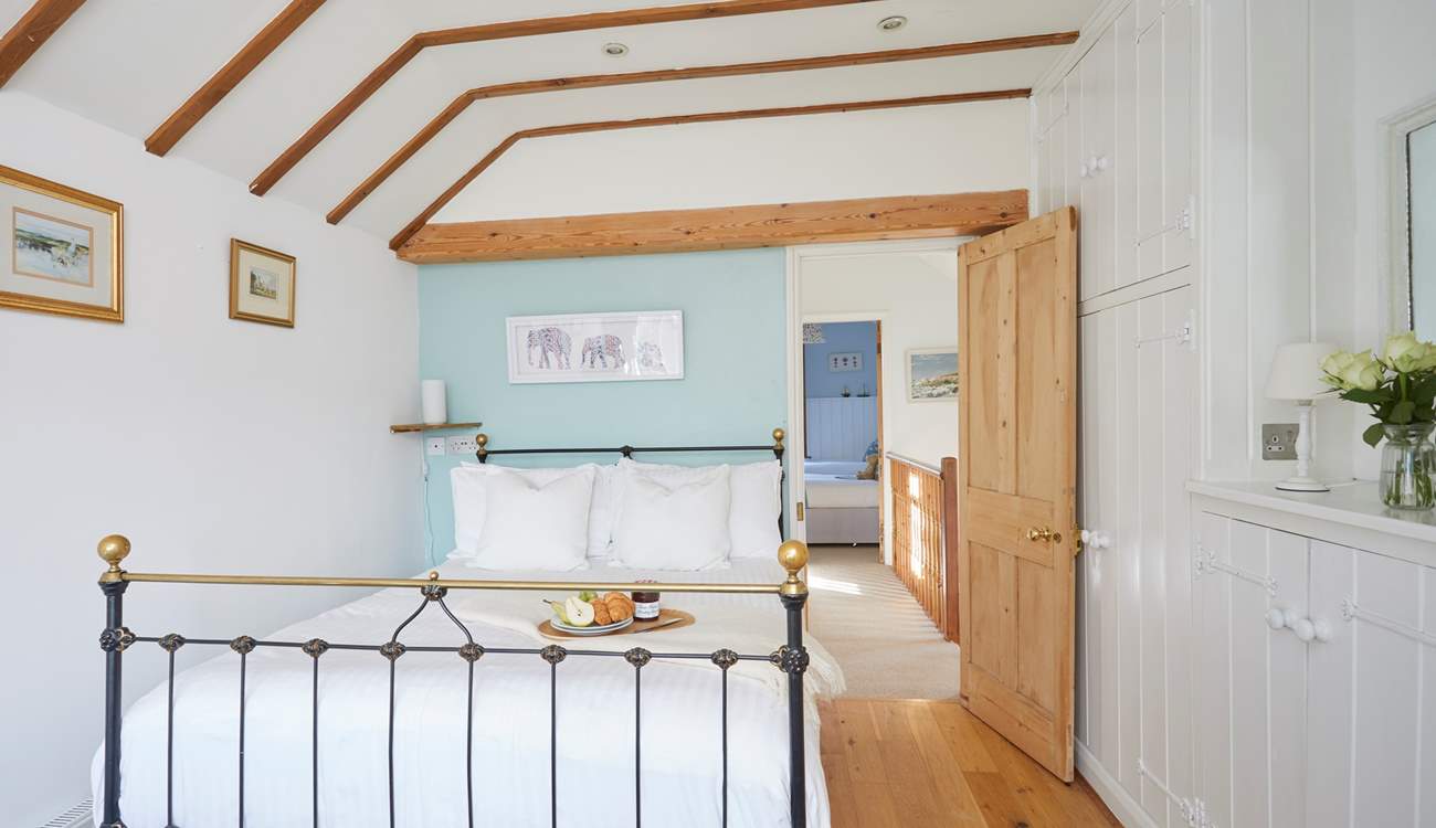 Bedroom 1 with double bed and en suite shower-room overlooks the pretty patio area.