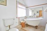 Take a long soak after a busy day in the stunning roll-top bath - please note there is a step up to the bath.
