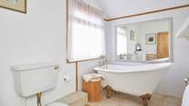 Take a long soak after a busy day in the stunning roll-top bath - please note there is a step up to the bath.