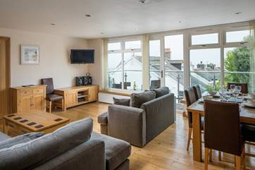 Looking back across into the living area from the kitchen. The living-room leads out onto a balcony area.