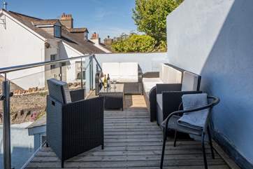 The balcony which leads out from bedroom three is such a glorious outside space, with seating for the whole party.
