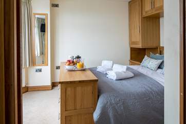 The annexe bedroom offers a bright and spacious place to retreat to for a peaceful night's sleep.